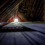Old attic space with roof rafters and a window