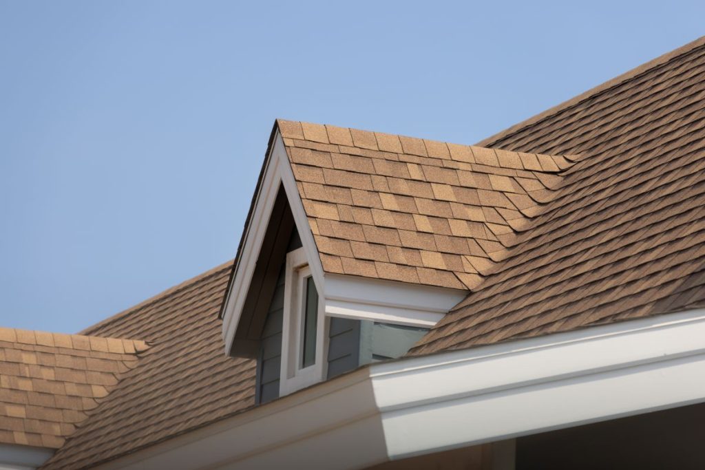 Roof shingles with garret house on top of the house, dark brown asphalt tiles on the roof. Edina, MN
