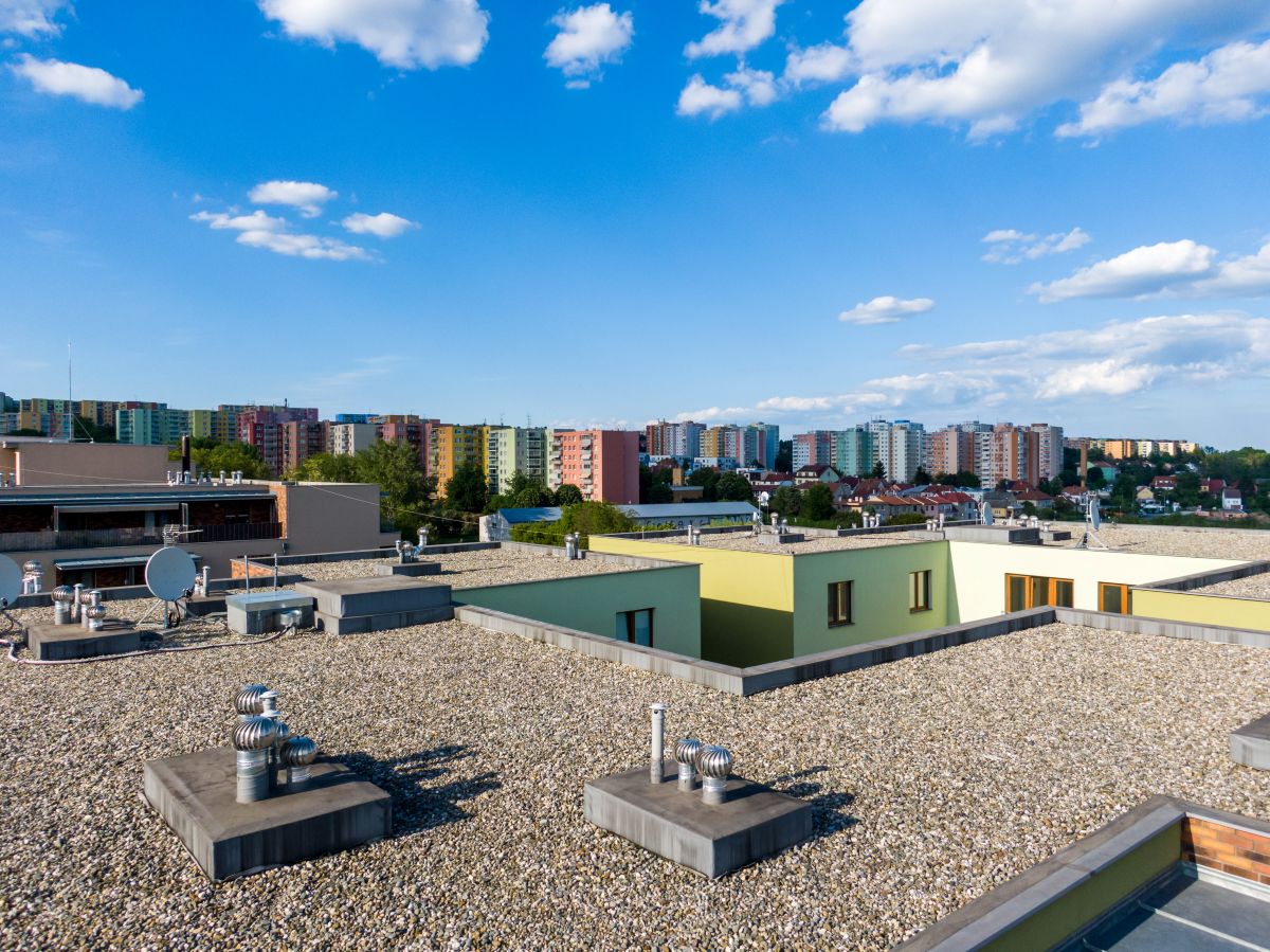 flat roof with colorful apartments in the background, Edina